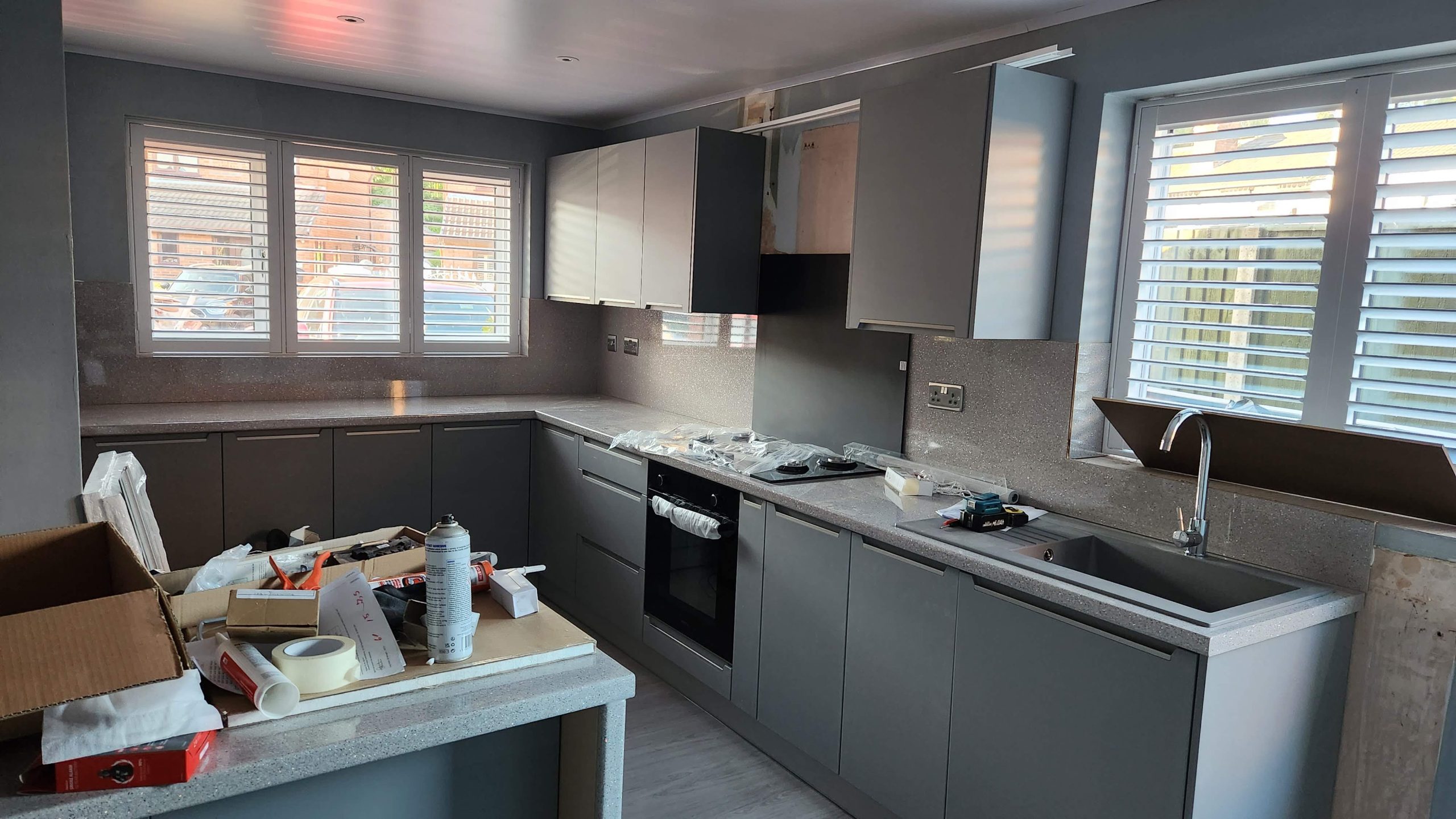 Kitchen part-way through fitting, with units and worktops in and tools on the floor